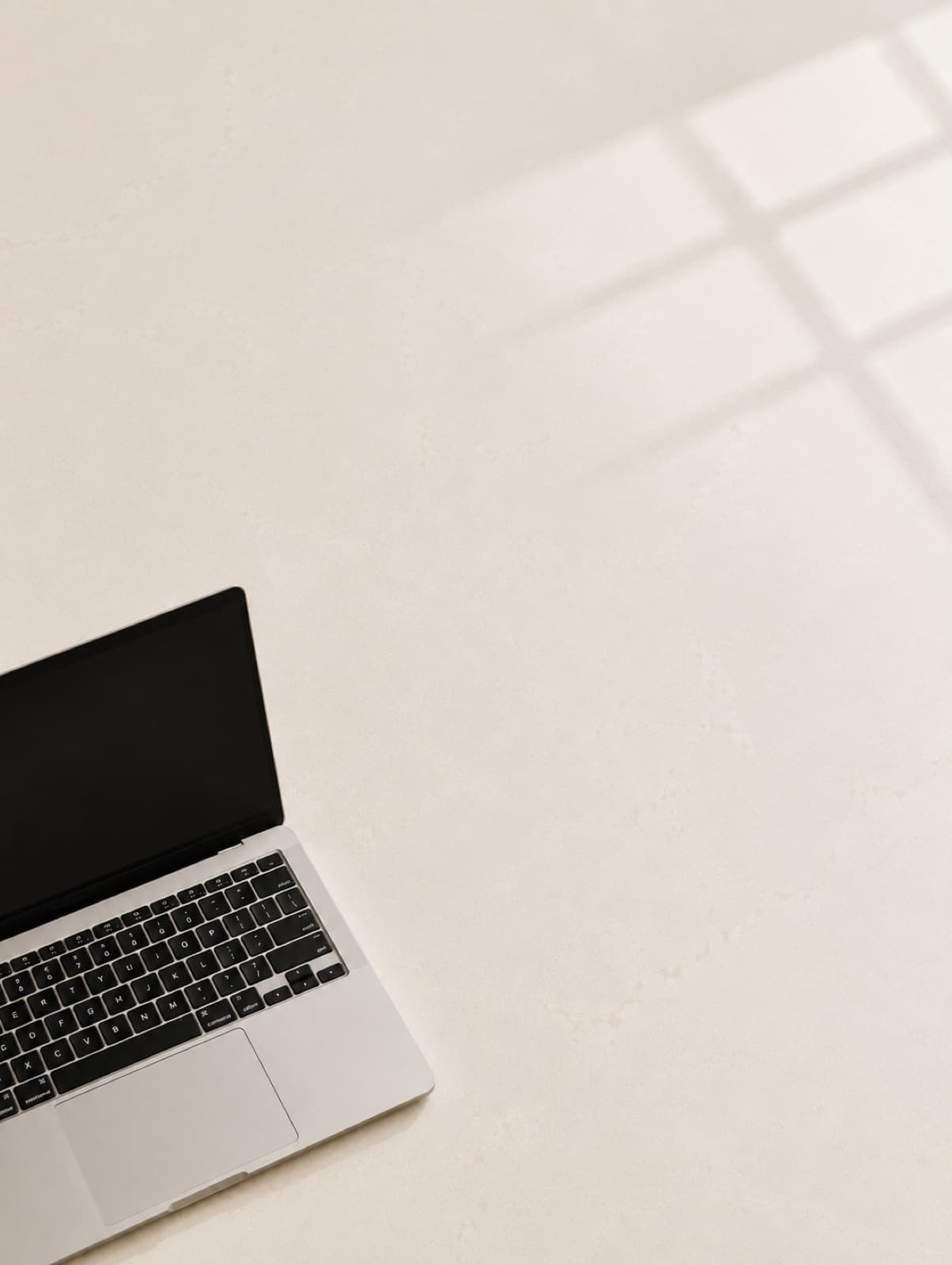 A laptop on a bright, minimal desk